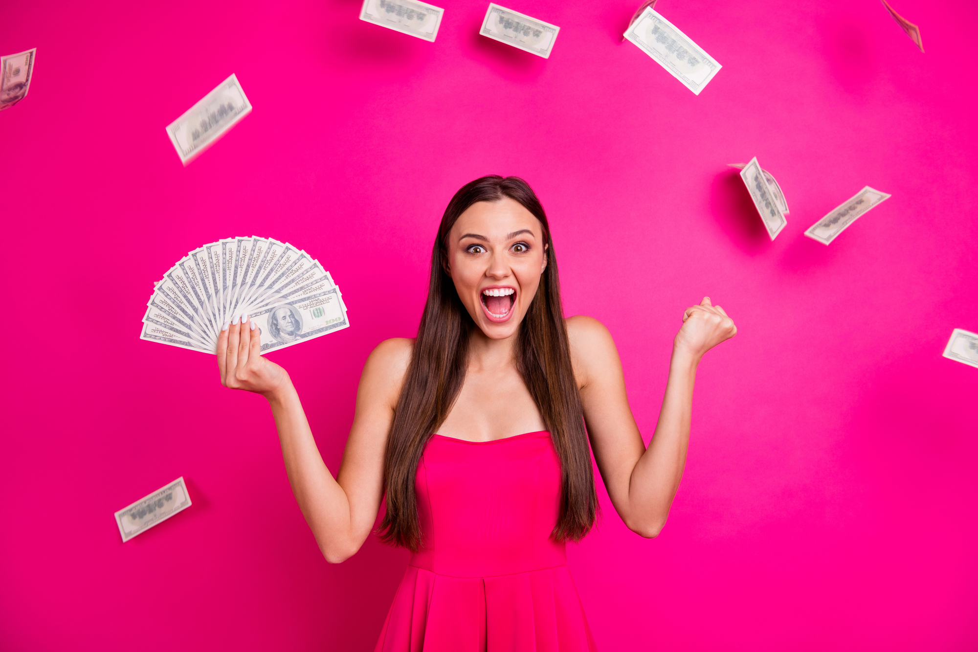 Portrait of her she nice attractive cheerful glad successful long-haired girl holding in hand big sum budget currency exchange isolated on bright vivid shine vibrant pink fuchsia color background